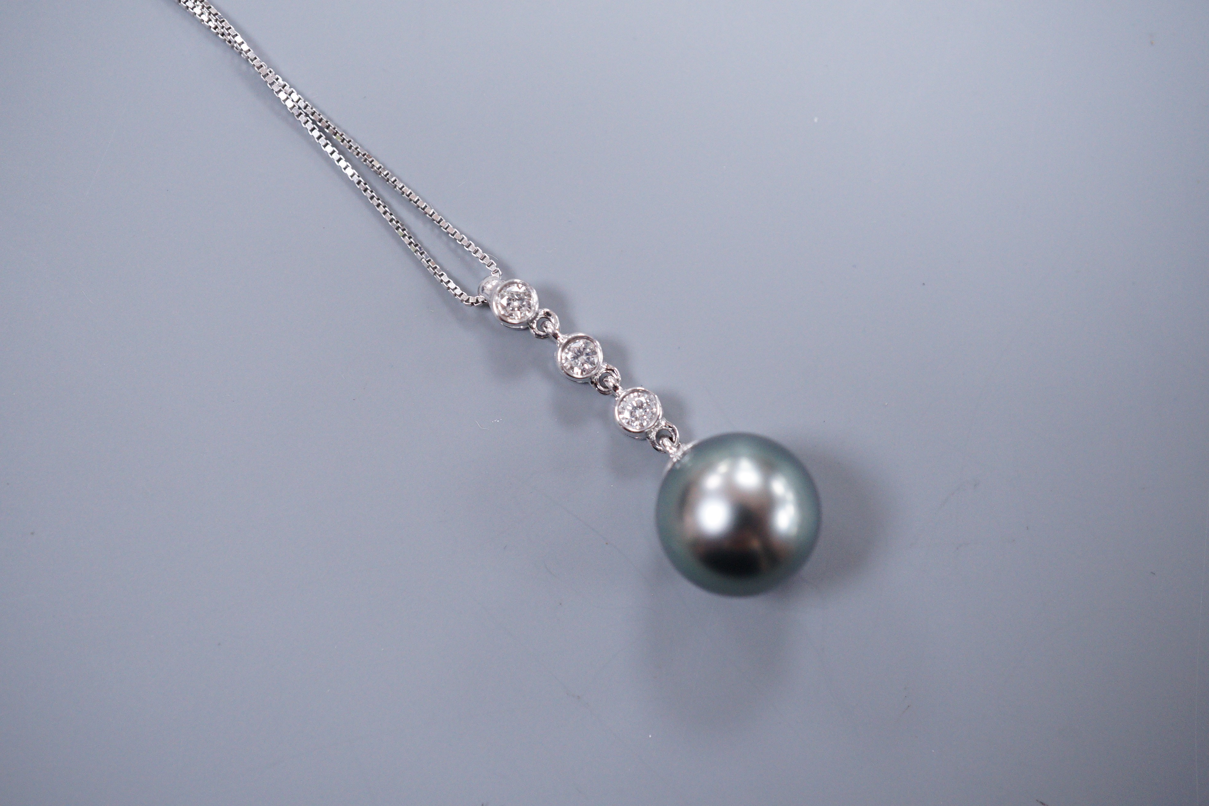 An Iliana 18ct white gold Tahitian pearl and diamond drop pendant, with original guarantee card and box